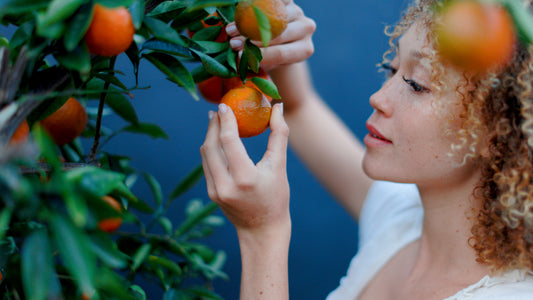 The quest for Glowing Skin - a woman looking to a orange